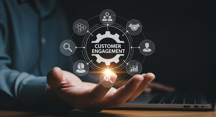 Person holding a glowing digital graphic representing customer engagement and business growth