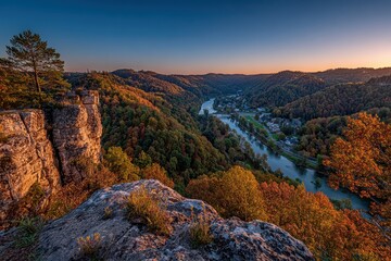 An amazing overlook view of the new river gorge, West Virginia, at sunset, with beautiful fall colors in the trees and clear sky creating the perfect scene.