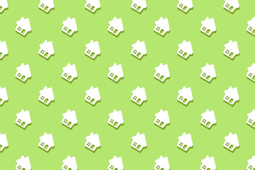 A repeating pattern of white house shapes on a green background. High quality photo