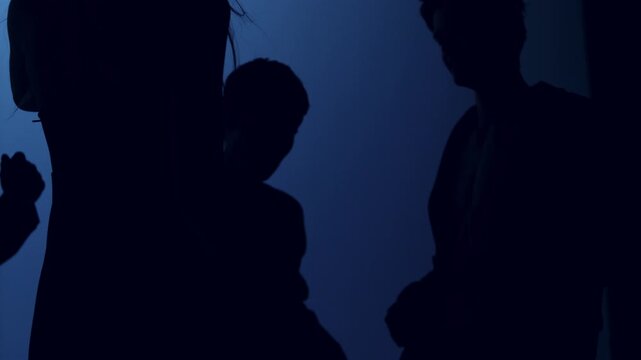 Extreme slow motion silhouette of young people dancing. Four friends move energetically against a bright background, captured at 1000 fps with a Phantom camera. Cinematic 4K ultra slow motion creating