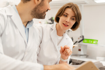 Fototapeta premium Scientists discussing research findings in laboratory setting