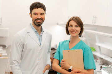 Fototapeta premium Doctors smiling in hospital laboratory or medical clinic wearing stylish uniform