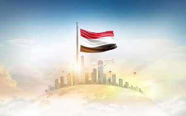 Yemen flag wavering on globe with modern building skyline. Flag waving on world map. Yemen national flag for independence day.
