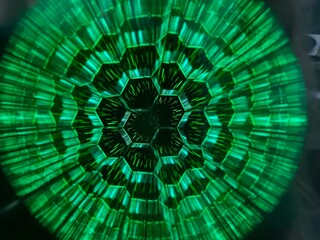 Neon green circular glow with hexagonal patterns on black background. Futuristic digital design concept with vibrant high-tech energy.