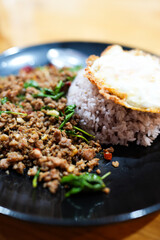 Thai stir fried basil with beef and crispy fried egg. Popular food of Thailand.