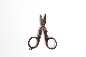 small rusty scissors full of dust isolated white background