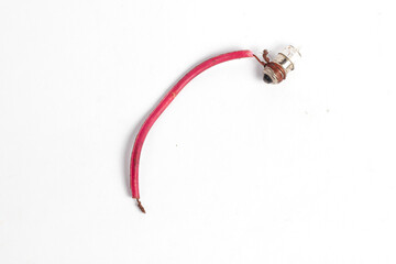 pilot lamp, a small lamp wrapped in cable, lit by a watch battery or accumulator, isolated on a white background. Usually used in motorcycle lighting.