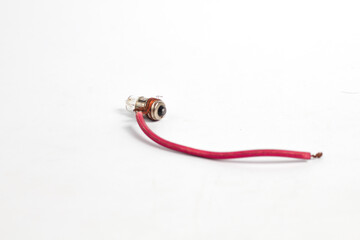 pilot lamp, a small lamp wrapped in cable, lit by a watch battery or accumulator, isolated on a white background. Usually used in motorcycle lighting.