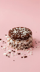 Delicious Chocolate Coconut Dessert Cake on Pink Background Sweet Treat Temptation Chocolate Covered Cake Coconut Shavings Modern Food Photography