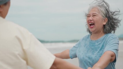 Asian Three Mature Women Celebrating Friendship and Joyful Retirement by Spinning Hand in Hand on a Beautiful Oceanfront Beach Getaway - Powered by Adobe