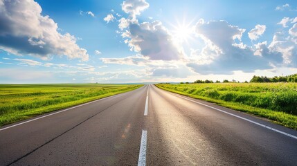 Fototapeta premium Highway Horizons: Dynamic Picture of Asphalt Highway – Smooth Black Pavement Cutting Through Green Fields and Distant Hills, Yellow Center Lines, Roadside Guardrails, and Trucks Speeding Under a Cloud