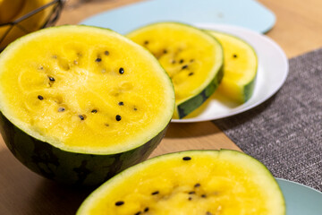 Close up shot of the cut watermelon with yellow flesh on ceramic plate. Food