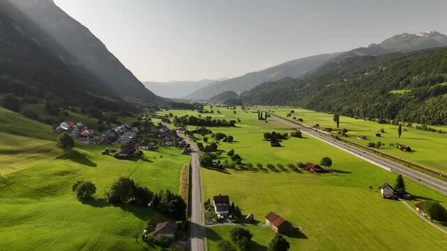 Aerial Drone View of Swiss Valley with Lush Green Fields and Majestic Mountain Scenery Near Flums, Berschis, and Walenstadt in St. Gallen, Switzerland