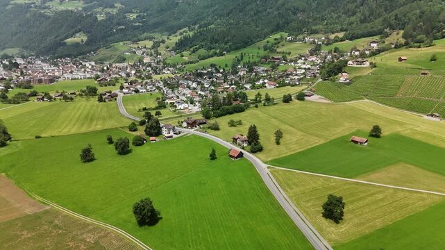 Scenic Aerial View of a Valley with Green Fields and Mountain Landscape in Switzerland near Flums, Berschis, and Walenstadt in the Canton of St. Gallen &ndash; Drone Footage