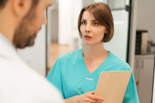 Female doctor explaining diagnosis to male patient in hospital