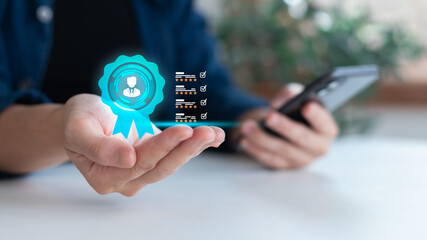 Hand holding virtual badge icon and rating checklist, representing digital skill certification, employee evaluation, and online professional profile review.