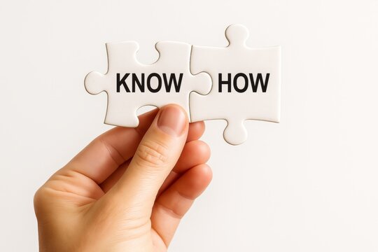 Knowledge Integration: A hand meticulously holds two puzzle pieces, artfully showcasing Know How, symbolizing expertise, skill, and the acquisition of vital knowledge.