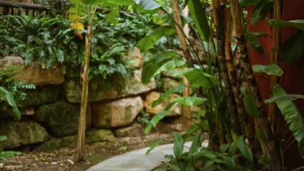 Lush tropical garden with blurred greenery creates a serene resort atmosphere with vibrant plants and peaceful outdoor luxury feel.