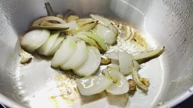 chopped onion and garlic are fried over high heat