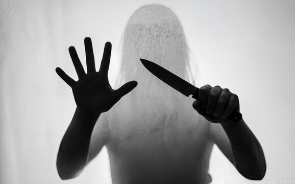 Horror silhouette of killer with knife for crime and fear concept.