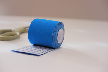 Taping equipment for sport injury recovery. Kinesiology tape roll.