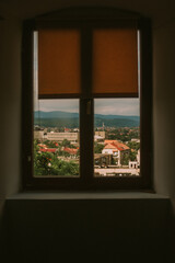 Warm light through old wooden windows, cozy interior with sunlight and architectural charm.