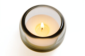 a lit candle is sitting in a glass