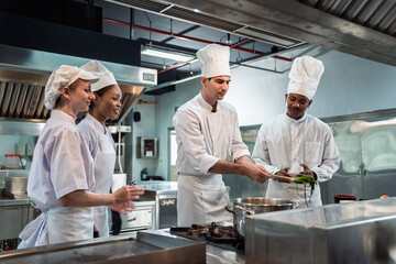 Cooking Class in Commercial Kitchen , Diverse Culinary Student Receives Hands-On Training from Head Chef, Learning with Passion and Focus