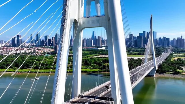 Modern cable stayed bridge spanning river cityscape