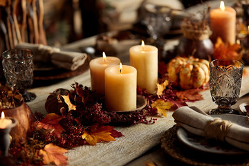 Warm Glow of Candles on a Rustic Autumnal Thanksgiving Dinner Table Setting