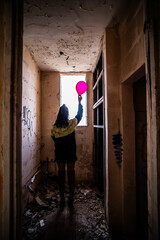 Halloween Pumpkin Head Girl in Urban Graffiti Scene with a red balloon.