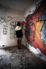 Halloween Pumpkin Head Girl in Urban Graffiti Scene with a red balloon.