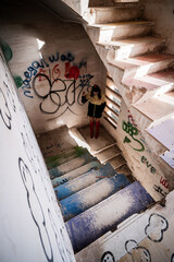 Halloween Pumpkin Head Girl in Urban Graffiti Scene with a red balloon.