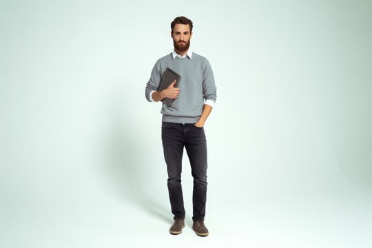 Man holding tablet with hand in pocket casual grey sweater - Powered by Adobe