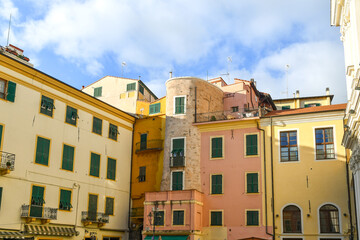 High-section of a corner of Piazza Cassini, a small square in the old town, with a medieval tower among colorful houses, Sanremo (Imperia), Liguria, Italy