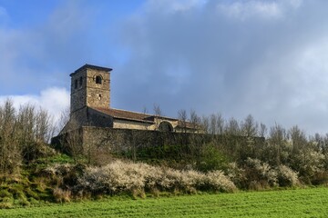 Fototapeta premium Church of Santa Eulalia in Las Heras de Palencia surrounded by trees