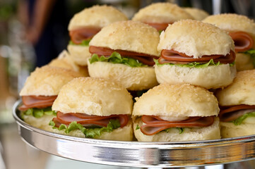 sandwich on a plate, sandwich with ham,  ham and lettuce mini sandwiches, elegant silver tray appetizers, delicious party sliders display