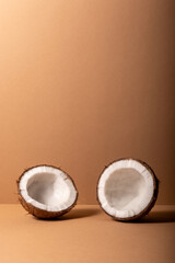 Cracked coconut on bright background. Summer tropical concept.