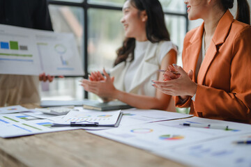 Businesswomen celebrating positive results in modern office