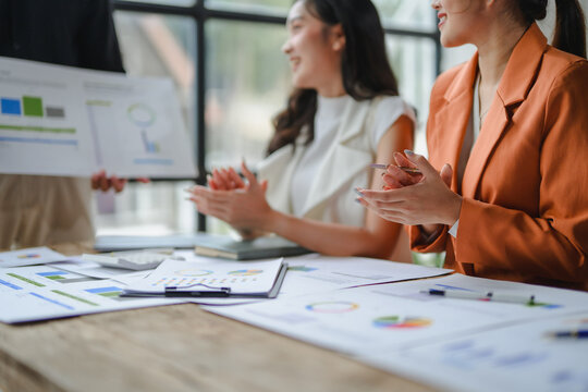 Businesswomen celebrating positive results in modern office - Powered by Adobe