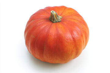 a small orange pumpkin on a white surface