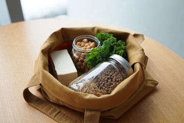 Ethical Eating Canvas Bag Overflowing with Vegan Staples Tofu Chickpeas Lentils and Kale for Sustainable Living