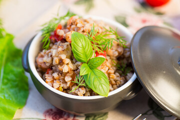 simple dinner. Cooked buckwheat with vegetables in a ceramic bowl