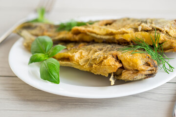 Traditional Ukrainian fried crucian carp in a village kitchen