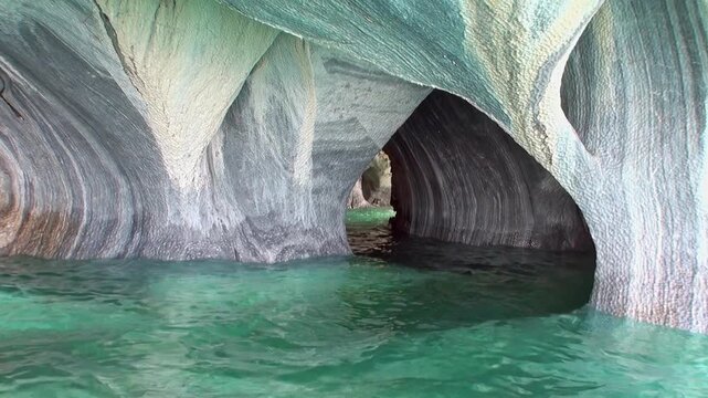 Navigate through the turquoise waters, revealing the mesmerizing Marble Caves. Witness the light dancing on the rock formations of Patagonia's Lago General Carrera.