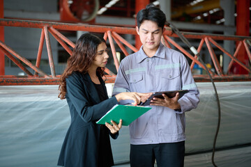Engineers and Businesswoman talking about work or project in the factory