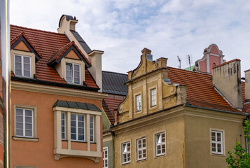 Colorful historic townhouses with red roofs in the Old Town of Poznań, Poland.