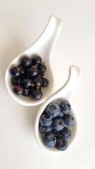 Mixed berries in white fruit, blueberry, blackcurrants in bowls. Healthy eating concept. Top view. Collection of berries in white bowls, isolated on white background 