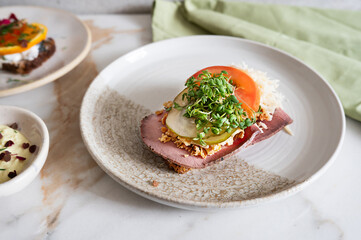 Roast beef, pickle, and horseradish smorrebrod Danish open faced sandwich.