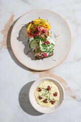 Open-faced sandwich with boiled eggs, shrimps, mayonnaise, fresh dill on dark rye bread and remoulade